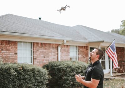 Home inspector using drone for roof inspection in Longview, TX