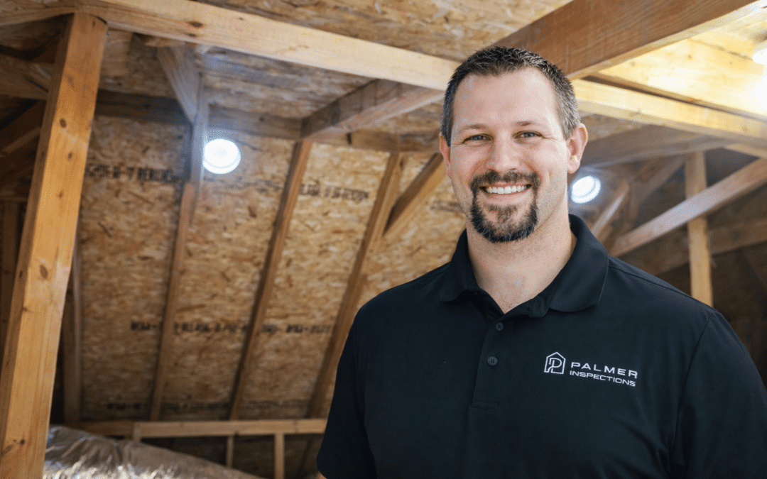 Home inspector from Palmer Inspections smiling during an attic inspection in an East Texas home