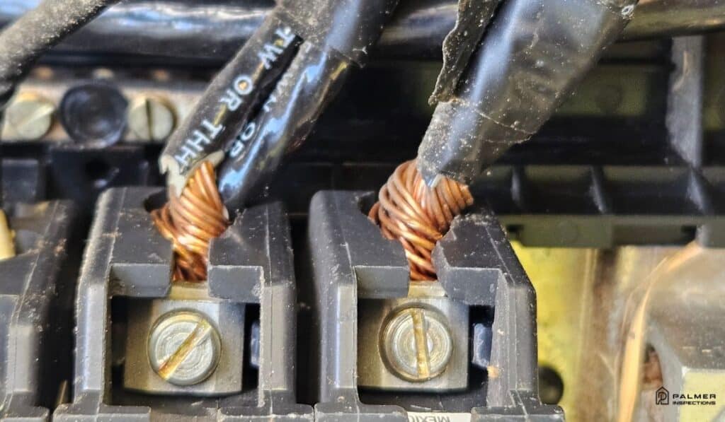 Close-up of copper wiring connections during an electrical panel safety check by Palmer Inspections in Tyler, TX.