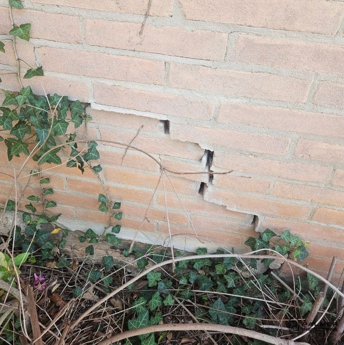 Stair-step cracking in brick veneer indicating foundation settling found during a home inspection in East Texas.