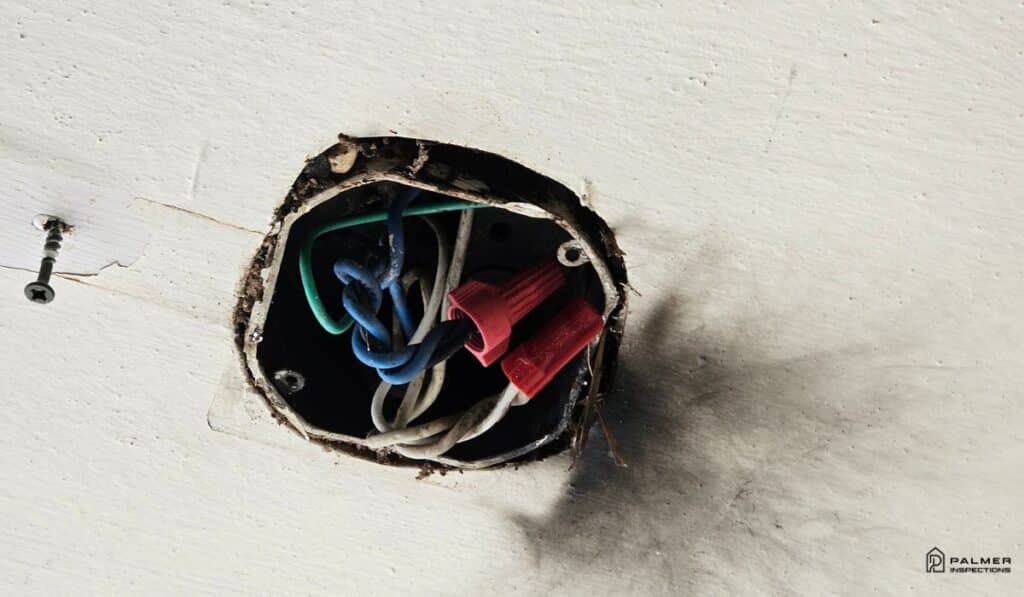 Do sellers have to fix everything after an inspection in Texas? Open electrical junction box with visible burn marks discovered during a home inspection in Henderson, TX.