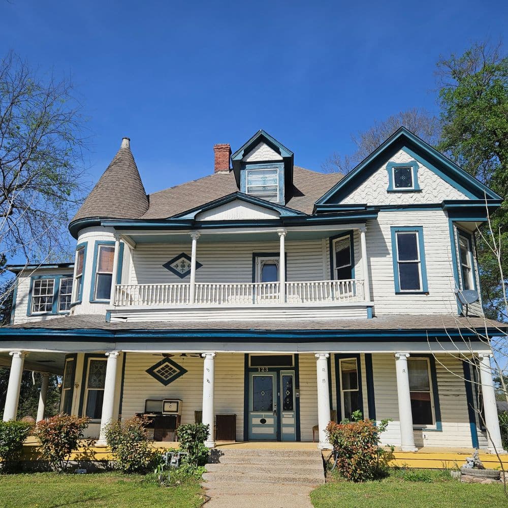 historic-exterior-home-inspection-marshall-tx Palmer Inspections exterior home inspection of a historic Victorian-style house with a large porch in Marshall, TX.